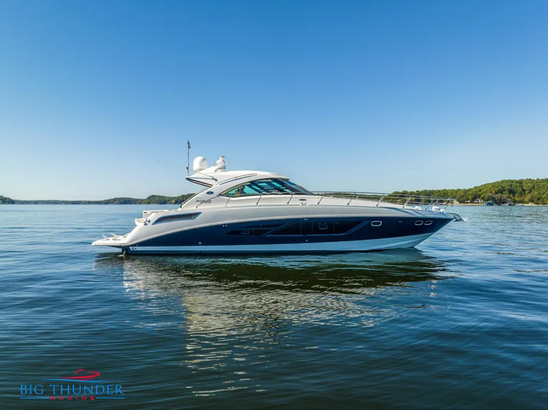 Slide: The Image of 2013 Sea Ray 540 Sundancer yacht on calm water under clear blue sky. - 0