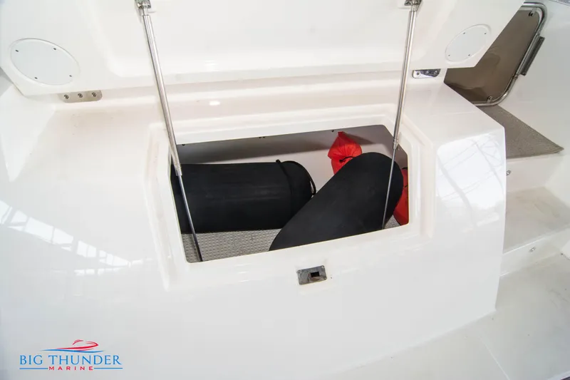Slide: The Image of 2013 Sea Ray 540 Sundancer storage compartment with gear and equipment. - 15