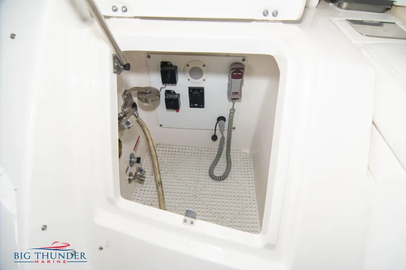 Slide: The Image of 2013 Sea Ray 540 Sundancer control panel and storage compartment. - 16