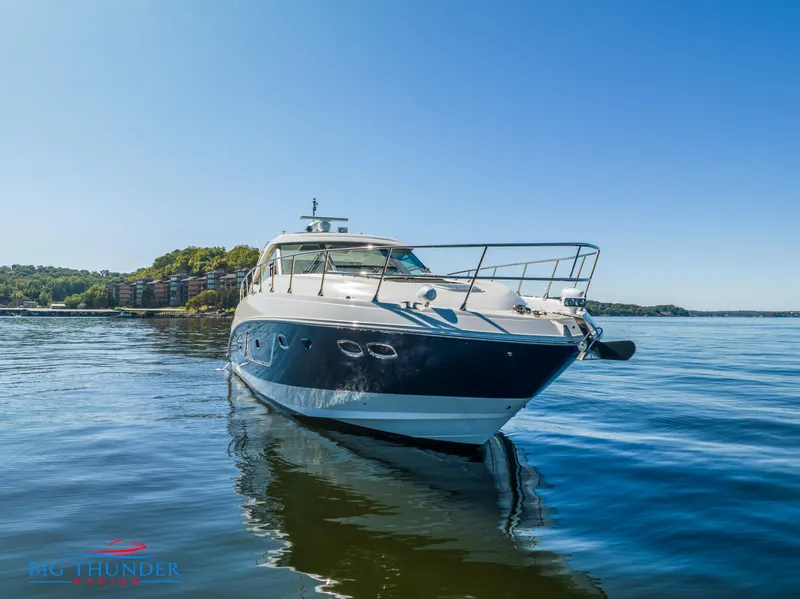 Slide: The Image of 2013 Sea Ray 540 Sundancer yacht on calm water under clear blue sky. - 2