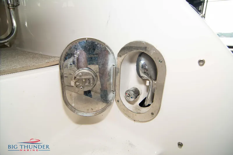 Slide: The Image of 2013 Sea Ray 540 Sundancer fuel cap and nozzle compartment. - 20