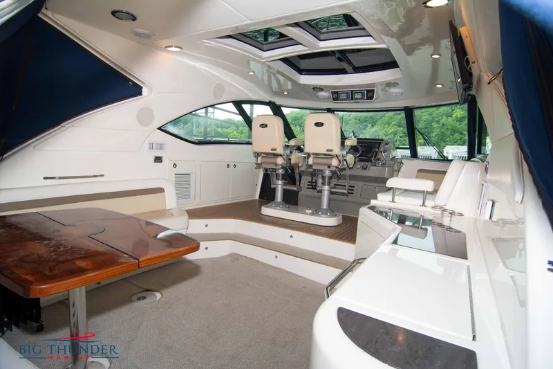 Slide: The Image of Interior of a 2013 Sea Ray 540 Sundancer yacht with helm and seating area. - 21