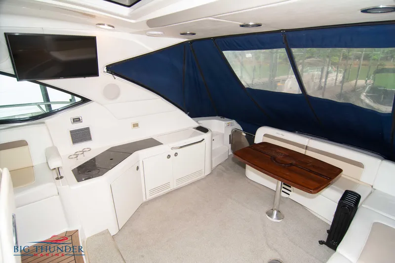 Slide: The Image of 2013 Sea Ray 540 Sundancer interior with seating, table, and TV. - 22