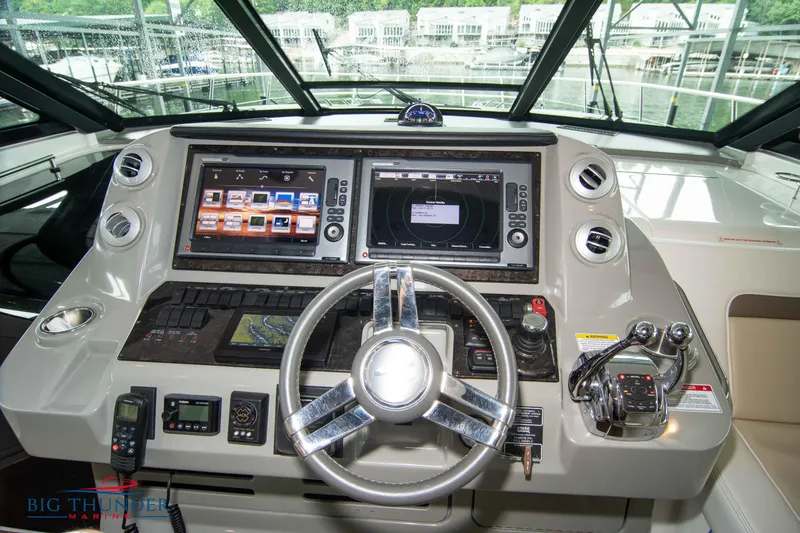 Slide: The Image of Helm of 2013 Sea Ray 540 Sundancer with dual navigation screens and modern controls. - 47
