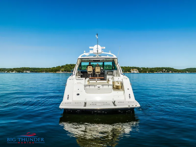 Slide: The Image of 2013 Sea Ray 540 Sundancer yacht on calm water, rear view. - 5
