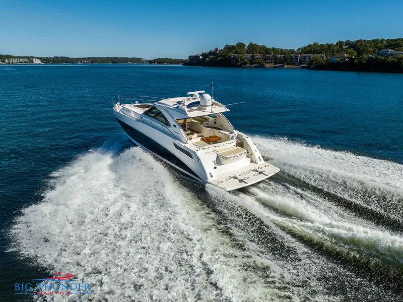 Slide: The Image of 2013 Sea Ray 540 Sundancer yacht cruising on a clear blue lake. - 6