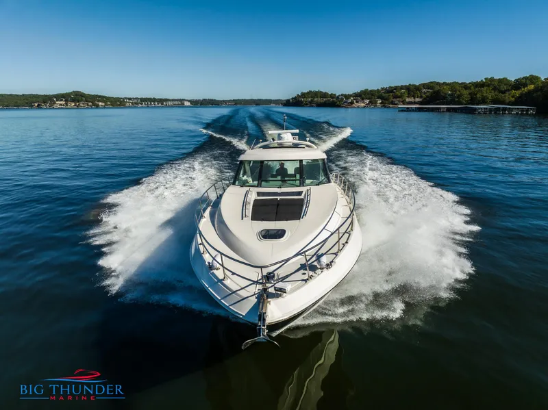Slide: The Image of 2013 Sea Ray 540 Sundancer cruising on a clear lake, creating a dynamic wake. - 8