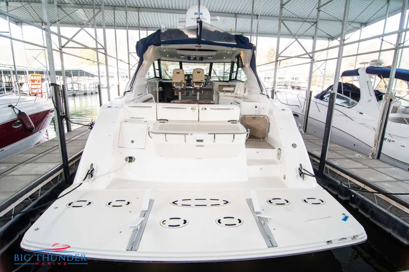 Slide: The Image of 2013 Sea Ray 540 Sundancer yacht docked in marina, rear view. - 12