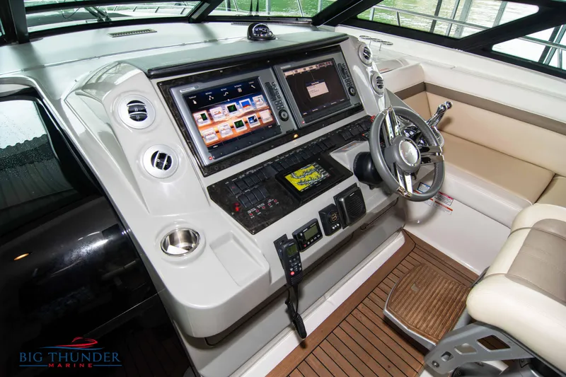 Slide: The Image of 2013 Sea Ray 540 Sundancer helm with advanced navigation systems and luxurious seating. - 45