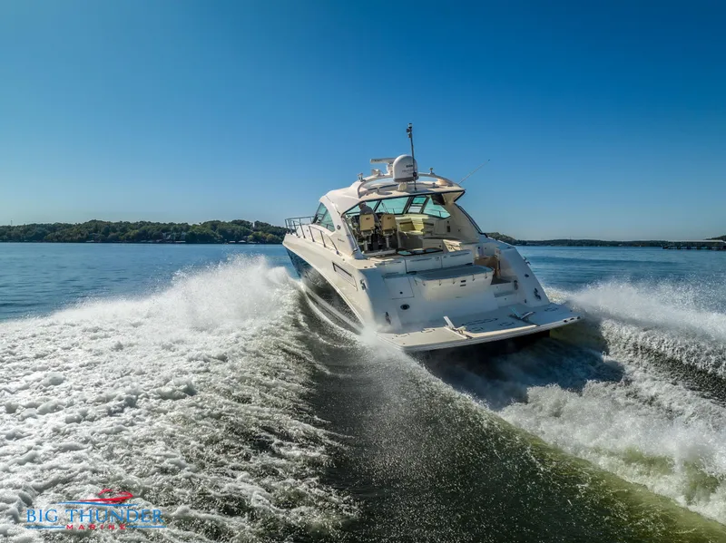 Slide: The Image of 2013 Sea Ray 540 Sundancer cruising on open water, creating a dynamic wake. - 9