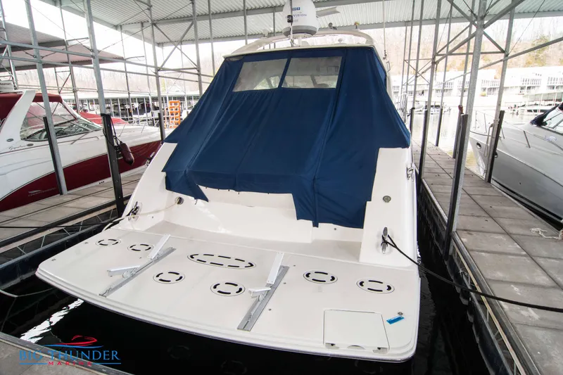 Slide: The Image of 2013 Sea Ray 540 Sundancer yacht docked with blue cover in marina. - 11
