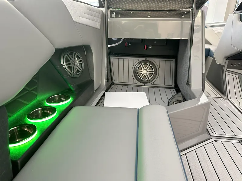 Slide: The Image of 2024 Nautique S23 boat interior with green LED cup holders and premium sound system. - 12