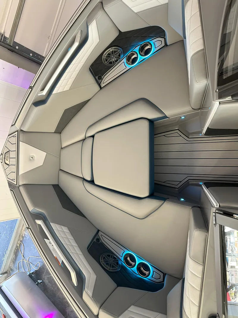 Slide: The Image of 2024 Nautique S23 boat interior with modern seating and illuminated cup holders. - 18