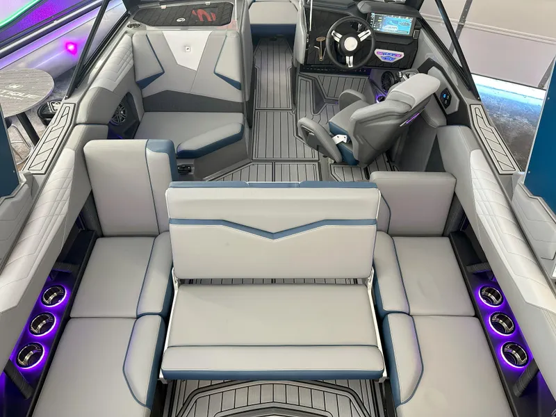 Slide: The Image of 2024 Nautique S23 boat interior with modern seating and illuminated cup holders. - 23
