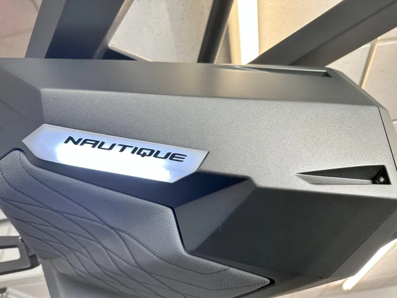 Slide: The Image of 2024 Nautique S23 boat detail with illuminated logo. - 24
