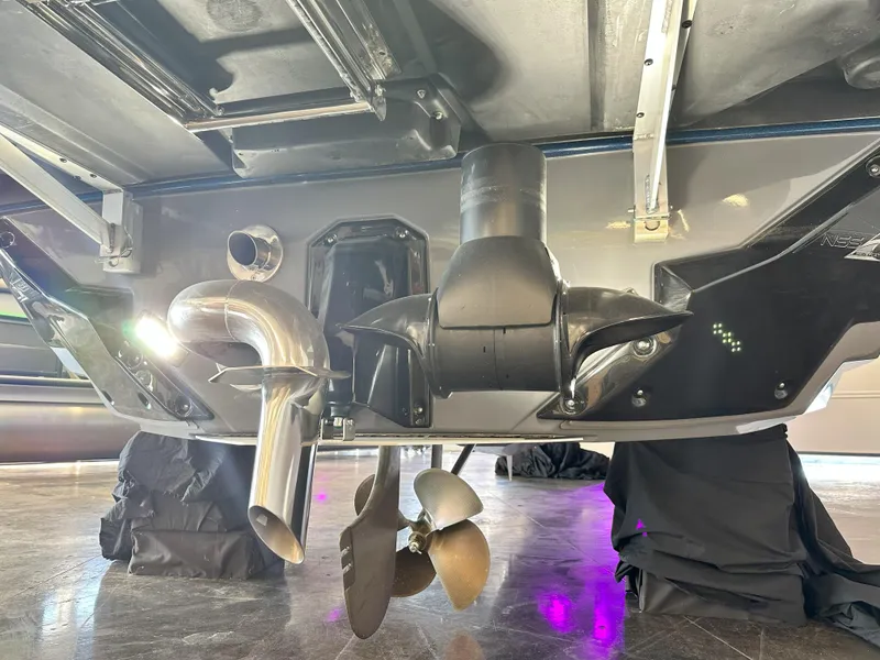 Slide: The Image of 2024 Nautique S23 boat underside showing propeller and exhaust system. - 25
