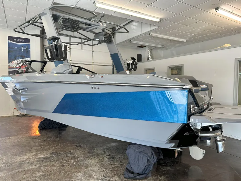 Slide: The Image of 2024 Nautique S23 boat in showroom, side view. - 7