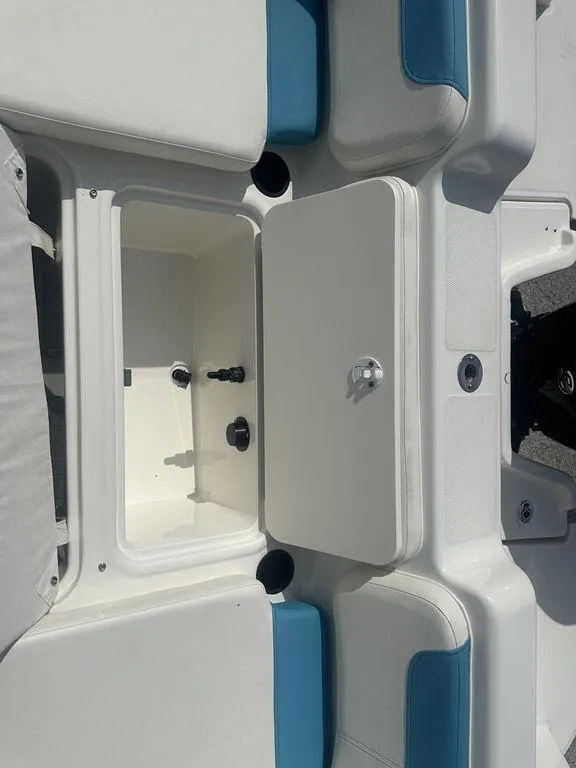 Slide: The Image of 2024 Bayliner Element E21 boat storage compartment with blue and white seating. - 14
