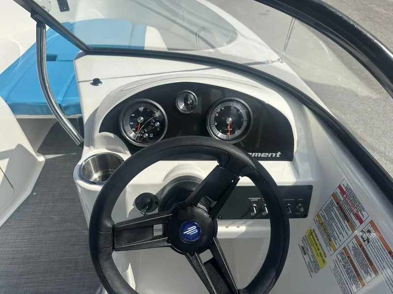 Slide: The Image of 2024 Bayliner Element E21 boat dashboard with steering wheel and gauges. - 15
