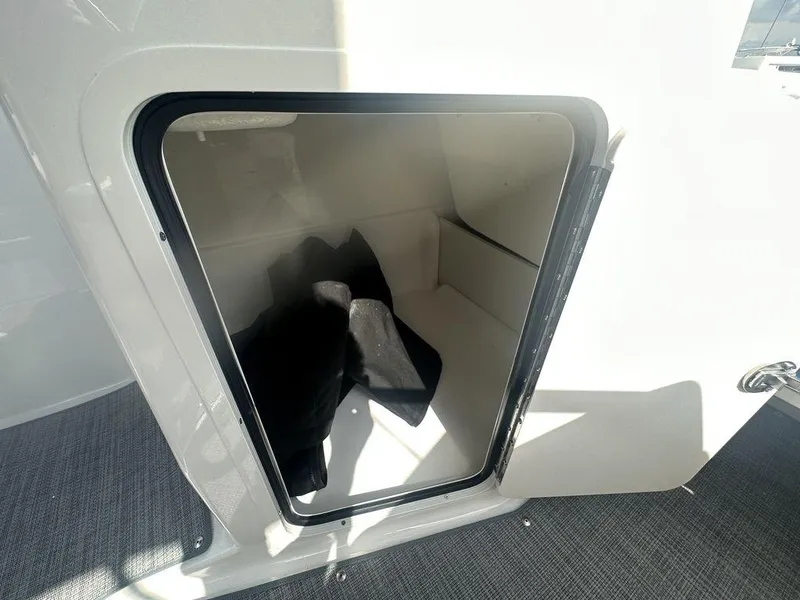 Slide: The Image of 2024 Bayliner Element E21 storage compartment with open hatch. - 18