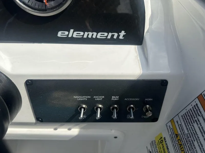 Slide: The Image of Control panel of 2024 Bayliner Element E21 boat with labeled switches. - 19