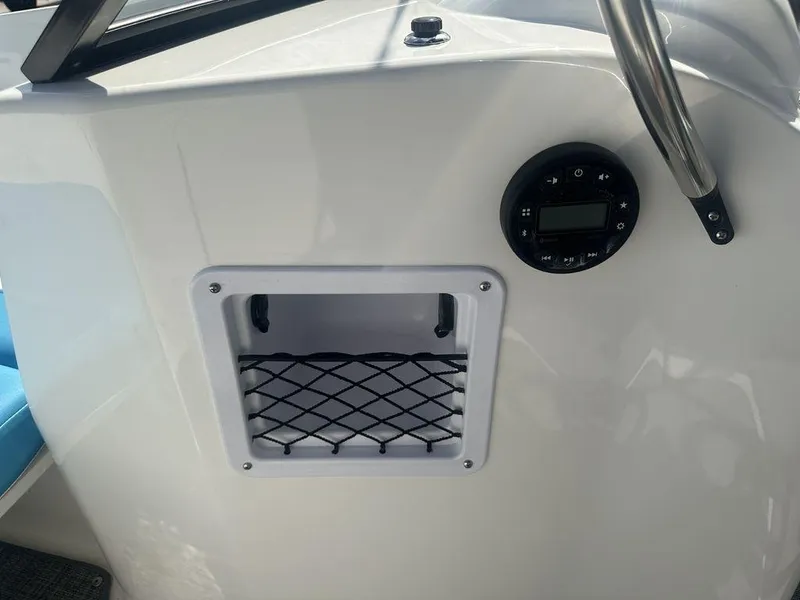 Slide: The Image of 2024 Bayliner Element E21 dashboard with storage compartment and control panel. - 20