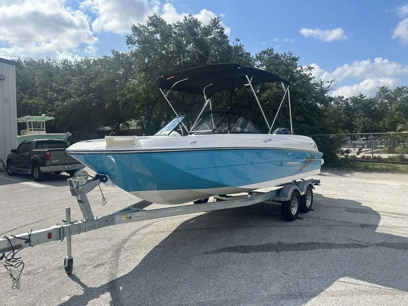 Slide: The Image of 2024 Bayliner Element E21 boat on a trailer in a parking lot. - 6