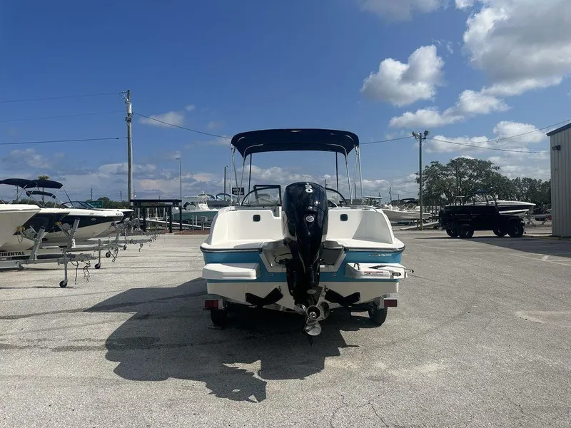 Slide: The Image of 2024 Bayliner Element E21 boat with outboard motor in a marina. - 7