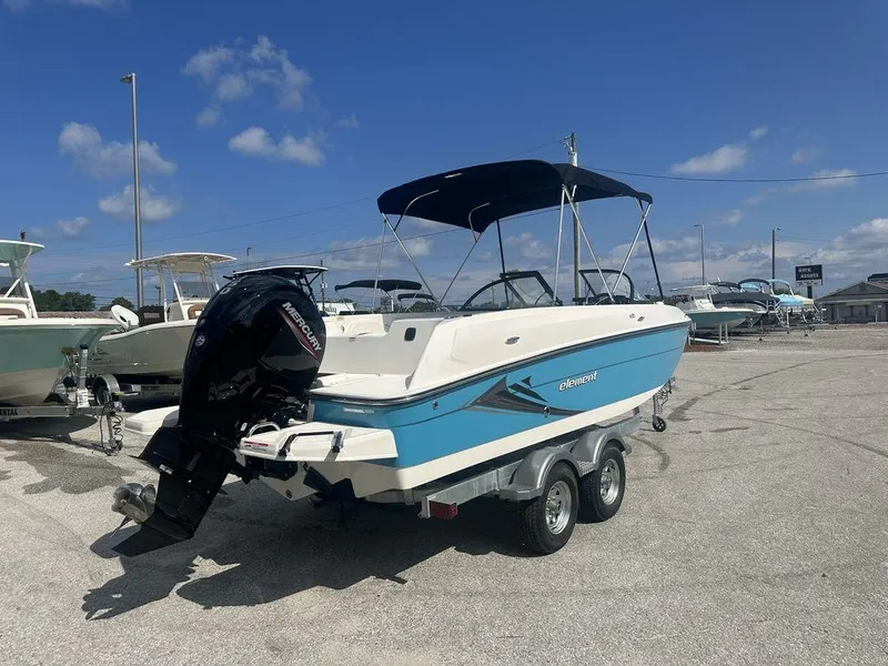 Slide: The Image of 2024 Bayliner Element E21 boat on a trailer in a marina. - 8