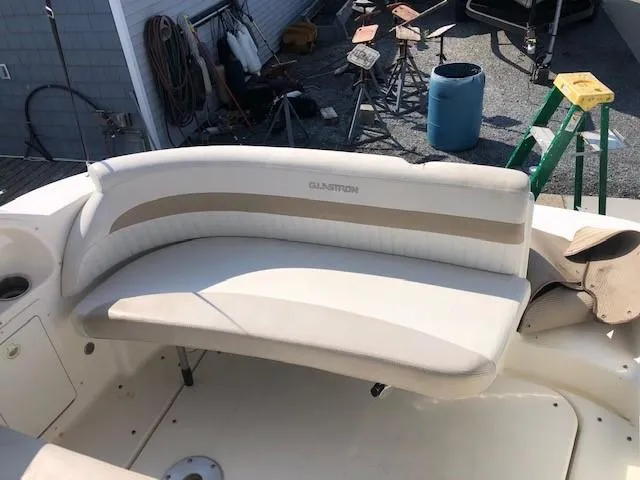 Slide: The Image of 2008 Glastron GS 259 boat interior with white and beige seating. - 10