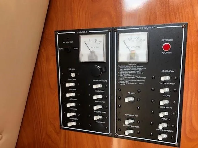 Slide: The Image of Control panel of a 2008 Glastron GS 259 boat with various switches and gauges. - 12