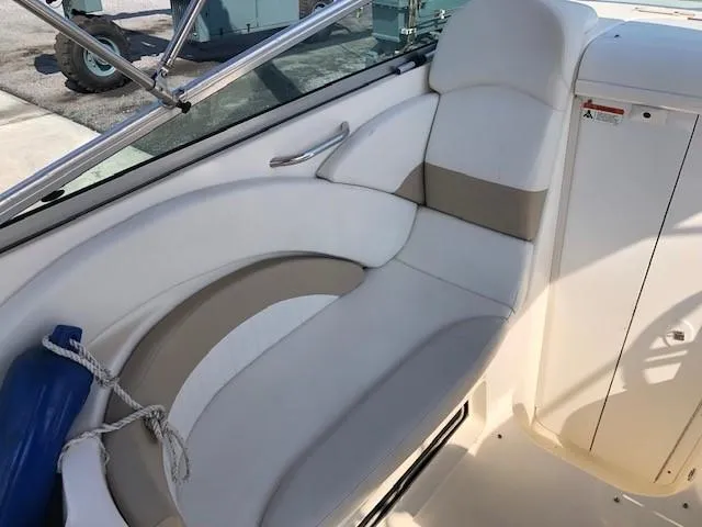 Slide: The Image of 2008 Glastron GS 259 boat interior seating area with white and beige upholstery. - 9