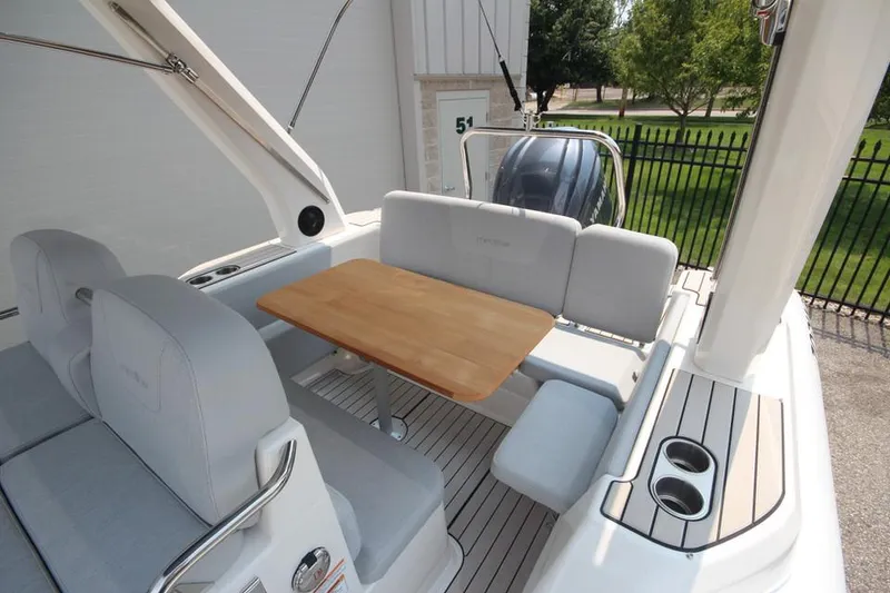 Slide: The Image of 2024 Zodiac Medline 7.5 NEO 300hp boat interior with seating and table. - 11