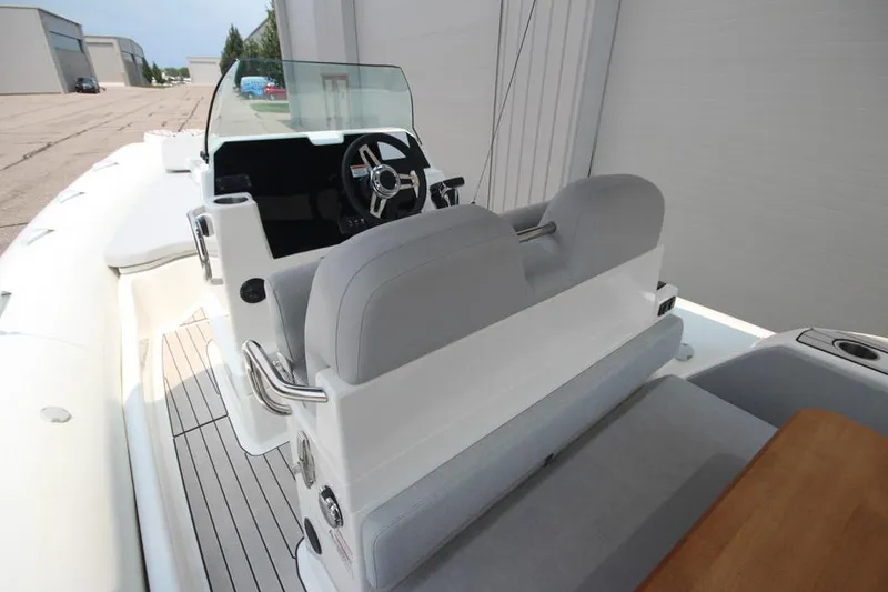 Slide: The Image of 2024 Zodiac Medline 7.5 NEO 300hp boat interior with steering console and seating. - 17