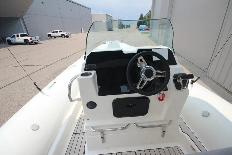 Slide: The Image of 2024 Zodiac Medline 7.5 NEO 300hp boat cockpit with steering wheel and controls. - 21