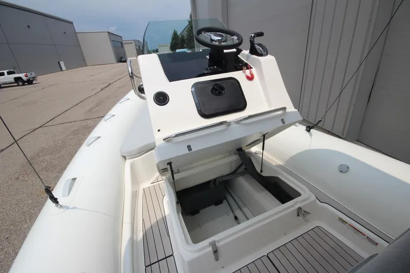 Slide: The Image of 2024 Zodiac Medline 7.5 NEO 300hp boat with open storage compartment. - 22