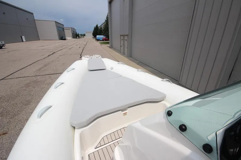 Slide: The Image of 2024 Zodiac Medline 7.5 NEO 300hp boat docked near industrial buildings. - 23