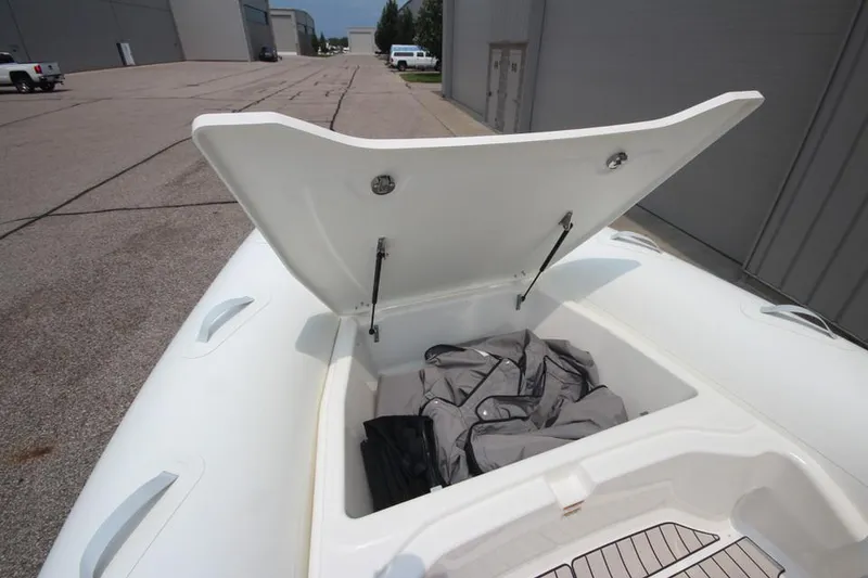 Slide: The Image of 2024 Zodiac Medline 7.5 NEO 300hp boat storage compartment open, showing interior space. - 30