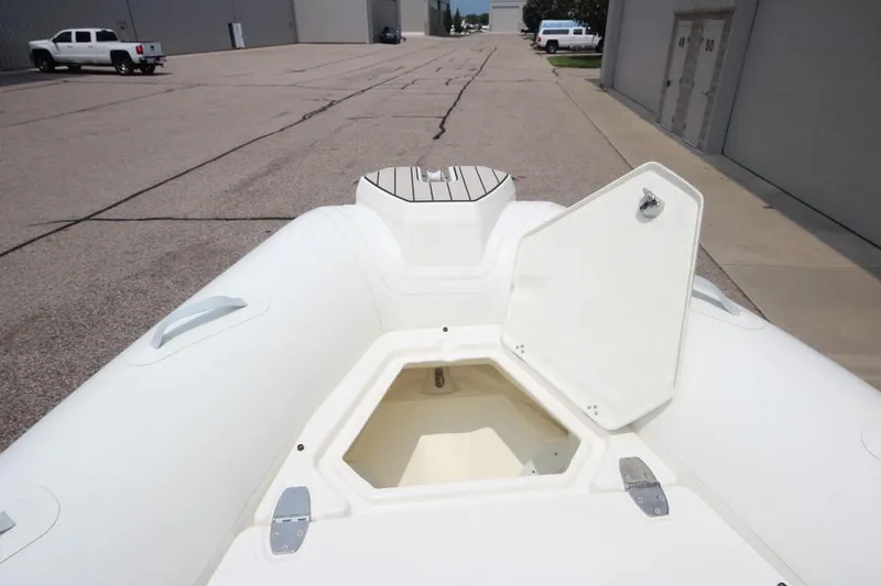 Slide: The Image of 2024 Zodiac Medline 7.5 NEO 300hp boat with open storage compartment. - 31