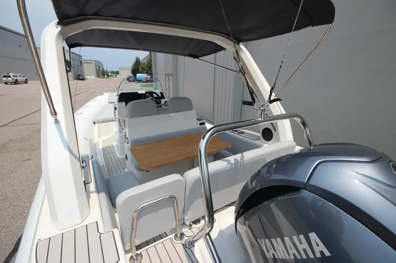 Slide: The Image of 2024 Zodiac Medline 7.5 NEO 300hp boat with Yamaha engine, rear seating, and table. - 9