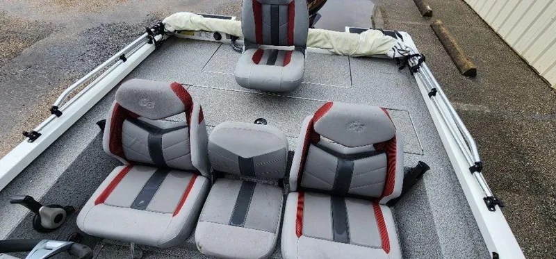 Slide: The Image of 2022 G3 Sportsman 1710 boat interior with gray and red seating. - 16