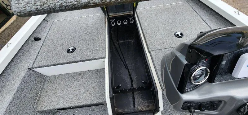 Slide: The Image of 2022 G3 Sportsman 1710 boat interior with storage compartments and motor detail. - 17