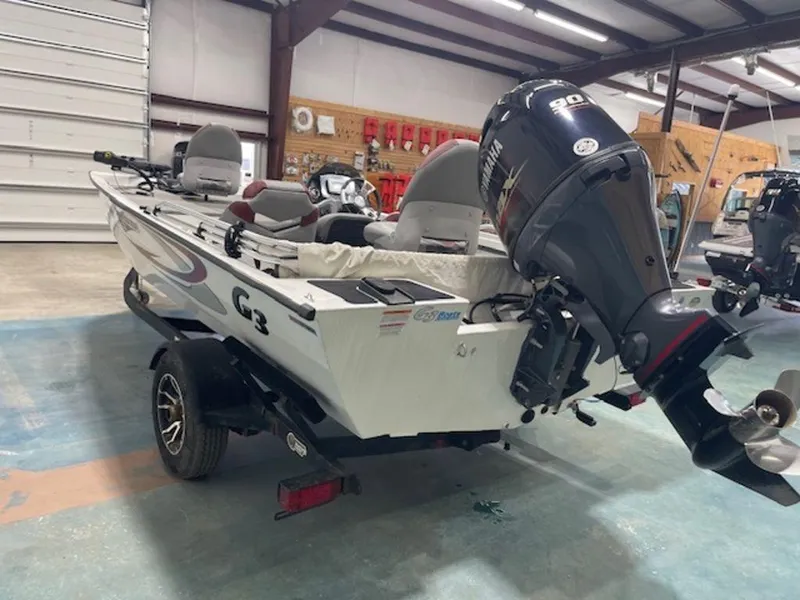 Slide: The Image of 2022 G3 Sportsman 1710 boat with motor in a garage setting. - 2