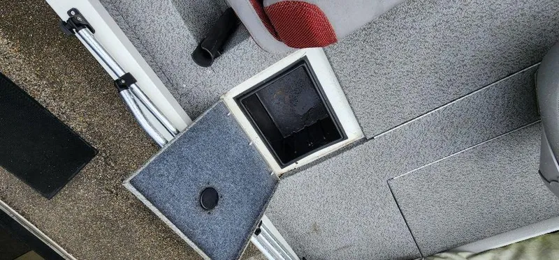 Slide: The Image of 2022 G3 Sportsman 1710 boat interior with open storage compartment and seating. - 27