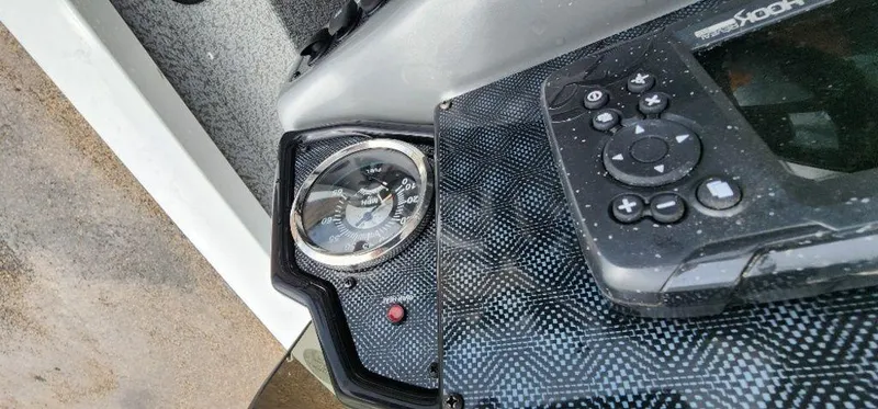 Slide: The Image of Close-up of 2022 G3 Sportsman 1710 boat dashboard with compass and control panel. - 31