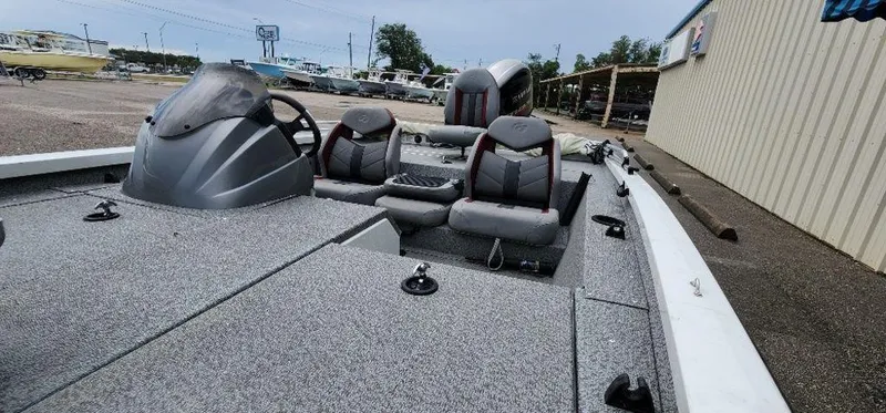 Slide: The Image of 2022 G3 Sportsman 1710 boat with dual seats and steering console in a marina setting. - 36