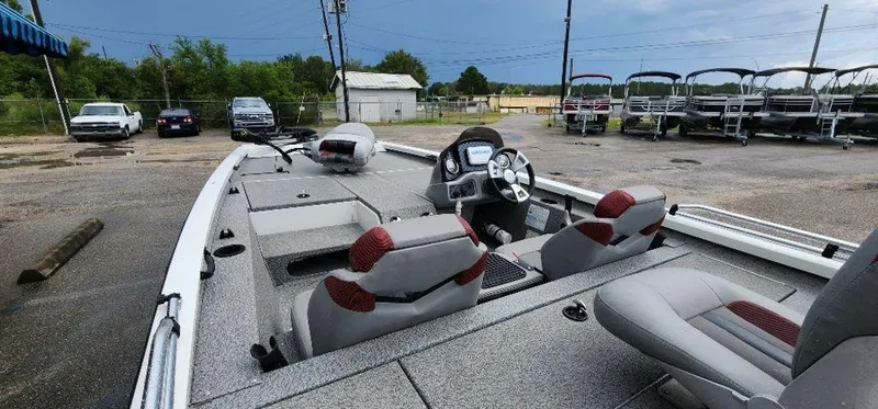 Slide: The Image of 2022 G3 Sportsman 1710 boat interior with seats and dashboard in a parking lot. - 37