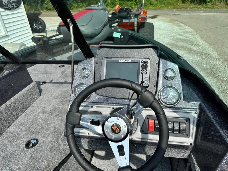 Slide: The Image of 2024 Ranger VS1682WT boat dashboard with steering wheel and Lowrance fishfinder. - 3