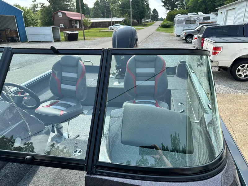 Slide: The Image of 2024 Ranger VS1682WT boat with dual seats and windshield in a residential area. - 7