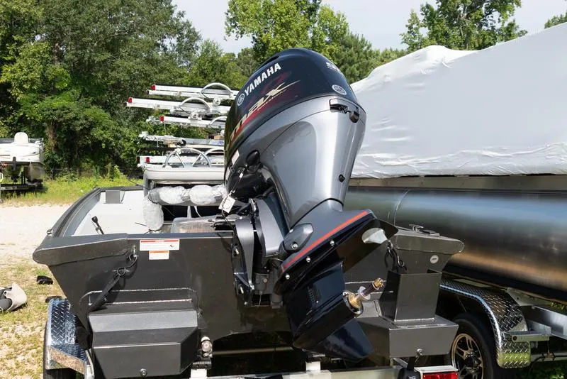 Slide: The Image of 2024 SeaArk RXT 180CC boat with Yamaha outboard motor in a storage yard. - 3